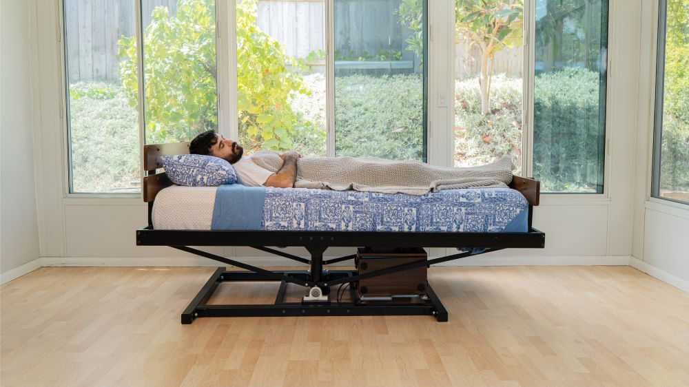 A person resting peacefully after falling asleep with the Rock and Sleep Bed